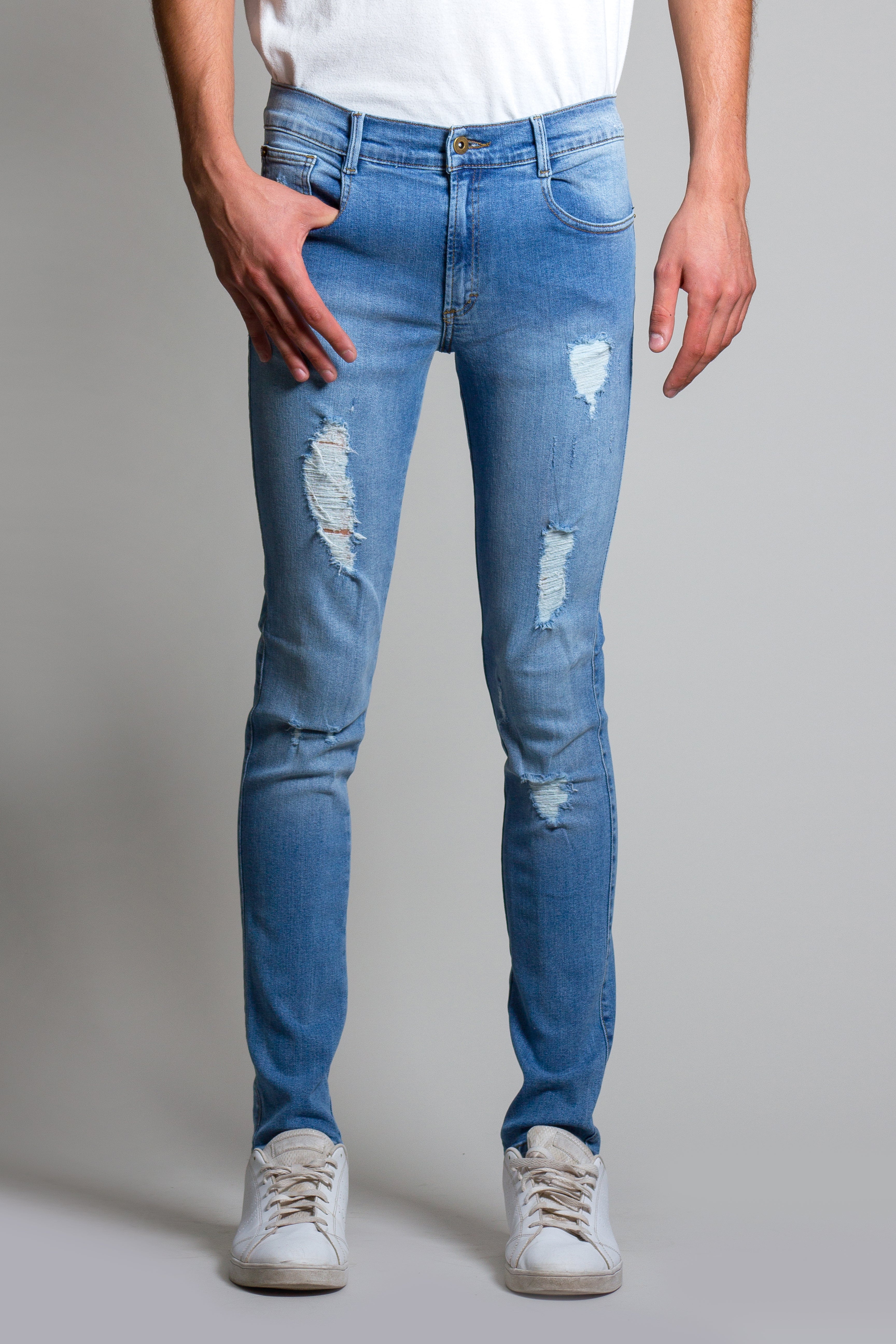 Jeans skinny de mezclilla stretch color azul medio con destrucción